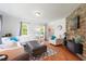 Cozy living room with a stone accent wall and comfortable seating arrangement at 135 Deep Creek, Rougemont, NC 27572