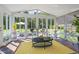 Bright sunroom featuring walls of windows and vaulted ceiling with beautiful backyard views at 135 Deep Creek, Rougemont, NC 27572