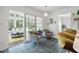 Bright sunroom connected to the kitchen, featuring tile floors and patio access at 135 Deep Creek, Rougemont, NC 27572