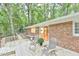 Wooden deck with outdoor seating providing an area for relaxation and overlooking the serene, wooded backyard at 128 Dixie Dr, Chapel Hill, NC 27514