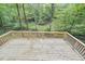 A well-maintained wooden deck offers an expansive view of the property's creek and wooded area at 128 Dixie Dr, Chapel Hill, NC 27514