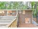 Multi-level deck offers a view of the home's brick exterior and access to the wooded backyard at 128 Dixie Dr, Chapel Hill, NC 27514