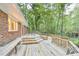 A spacious wood deck offers a view of the wooded backyard and access to the house at 128 Dixie Dr, Chapel Hill, NC 27514