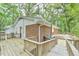 Multi-level wooden deck leading to brick and siding exterior, creating an outdoor oasis with a view at 128 Dixie Dr, Chapel Hill, NC 27514