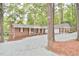 Charming home with brick and white siding, complimented by a spacious gravel driveway surrounded by mature trees at 128 Dixie Dr, Chapel Hill, NC 27514