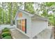 Stylish white house with an arch window complemented by green landscaping and lush trees at 128 Dixie Dr, Chapel Hill, NC 27514