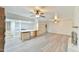 Open concept living room with an island, wet bar, and a fireplace at 128 Dixie Dr, Chapel Hill, NC 27514