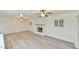 Spacious living room with light gray wood flooring and a white-painted brick fireplace at 128 Dixie Dr, Chapel Hill, NC 27514