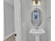 Powder room featuring pedestal sink, oval mirror, and modern lighting at 3109 Petrea Ct # 39, Angier, NC 27501