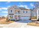 Two-story home with an inviting exterior, featuring a quaint balcony and a two-car garage for convenience at 3109 Petrea Ct # 39, Angier, NC 27501