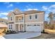 Elegant two-story home boasting a cozy balcony, a two-car garage, and charming curb appeal at 3109 Petrea Ct # 39, Angier, NC 27501