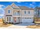Charming two-story home featuring a cozy balcony, two-car garage, and a neatly landscaped front yard at 3109 Petrea Ct # 39, Angier, NC 27501