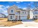 Stylish two-story home showcasing a balcony and a two-car garage, set within a well-maintained landscape at 3109 Petrea Ct # 39, Angier, NC 27501
