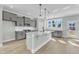 Open-concept kitchen with gray cabinetry, granite counters, island, and stainless appliances at 3109 Petrea Ct # 39, Angier, NC 27501