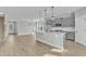 Open kitchen features gray cabinets, granite countertops, pendant lighting, and stainless appliances at 3109 Petrea Ct # 39, Angier, NC 27501