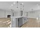 Open concept kitchen features stainless steel appliances, grey cabinetry, and a large island at 3109 Petrea Ct # 39, Angier, NC 27501