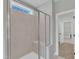 Neutral-colored shower with glass doors and a built-in bench, located near the laundry room at 3109 Petrea Ct # 39, Angier, NC 27501