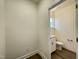 Powder room showcases a window providing natural light, paired with modern fixtures and white cabinets at 490 Traditions Grande Blvd # 27, Wake Forest, NC 27587