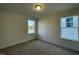 Cozy bedroom with natural light from two windows, carpeted flooring, and neutral wall paint at 490 Traditions Grande Blvd # 27, Wake Forest, NC 27587