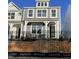 New construction townhouse showcasing a gray exterior, black wrought iron fence and tasteful stone accents at 490 Traditions Grande Blvd # 27, Wake Forest, NC 27587