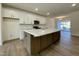 Modern kitchen with a large island, white cabinets, marble countertops, and stainless steel appliances at 490 Traditions Grande Blvd # 27, Wake Forest, NC 27587