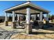 Community pavilion featuring stone and wood construction with picnic tables for outdoor enjoyment at 490 Traditions Grande Blvd # 27, Wake Forest, NC 27587