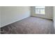 Neutral bedroom with gray carpet and natural light from a window at 9229 Kitchin Farms Way # 427, Wake Forest, NC 27587