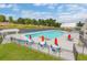 Community pool with tables, chairs, umbrellas, and shaded lounging area at 9229 Kitchin Farms Way # 427, Wake Forest, NC 27587