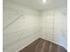 Walk-in closet with carpeted floor and built-in shelving system at 9229 Kitchin Farms Way # 427, Wake Forest, NC 27587
