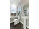 Stylish powder room featuring patterned wallpaper, a modern pedestal sink, and a window for natural light at 104 Ailey Brook Way # 200, Wake Forest, NC 27587