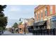 Charming street view featuring vintage buildings with awnings and American flags displayed at 104 Ailey Brook Way # 200, Wake Forest, NC 27587