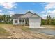 Gray siding one-story house with a two-car garage and front porch at 1516 Nc 55, Coats, NC 27521