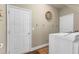 Functional laundry room with washer, dryer, and extra storage at 220 Clubhouse Dr, Youngsville, NC 27596