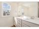 Bathroom featuring a double sink vanity with quartz countertop, ample natural light at 46 Lupin Dr, Smithfield, NC 27577