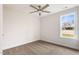 Well-lit bedroom with neutral carpet, ceiling fan and large window at 306 E Godwin St, Dunn, NC 28334