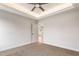 Bedroom with tray ceilings, neutral carpet, and a ceiling fan at 306 E Godwin St, Dunn, NC 28334