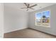 Bright bedroom with neutral carpet, ceiling fan, and a large window offering ample natural light at 306 E Godwin St, Dunn, NC 28334