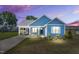 Charming blue home with white trim, black front door, and covered carport at 306 E Godwin St, Dunn, NC 28334