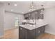 Modern kitchen with gray cabinets, quartz countertops, stainless appliances, and stylish pendant lighting at 306 E Godwin St, Dunn, NC 28334