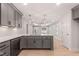 Open-concept kitchen with white quartz countertops, stainless appliances, and grey cabinetry at 306 E Godwin St, Dunn, NC 28334
