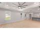 Living room featuring wood floors, white walls, bright windows, and an open layout to the kitchen at 306 E Godwin St, Dunn, NC 28334