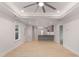 Open concept living room with wood floors and view of the gray kitchen with white countertops at 306 E Godwin St, Dunn, NC 28334