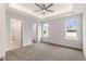 Bright main bedroom features a tray ceiling, neutral carpet, and ensuite bathroom entrance at 306 E Godwin St, Dunn, NC 28334