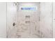 Modern tiled shower with a window and built-in storage niches at 306 E Godwin St, Dunn, NC 28334
