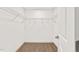 Empty walk-in closet with wire shelving and neutral carpeting at 306 E Godwin St, Dunn, NC 28334