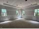 Large bedroom featuring three bright windows and a tray ceiling at 67 Ridgeline Ct # 7, Pittsboro, NC 27312