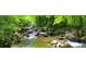 Scenic creek view winding through a lush, wooded area with rocky terrain at 67 Ridgeline Ct # 7, Pittsboro, NC 27312