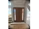 Modern entryway with wood door, side lights and transom window, during ongoing construction at 67 Ridgeline Ct # 7, Pittsboro, NC 27312