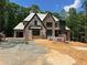 New construction showcasing the exterior of a two-story brick home with modern design elements at 67 Ridgeline Ct # 7, Pittsboro, NC 27312