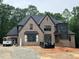 New brick home construction with black roof and modern design; lots of natural light and curb appeal at 67 Ridgeline Ct # 7, Pittsboro, NC 27312